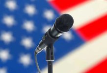 Microphone with blurred American flag background.