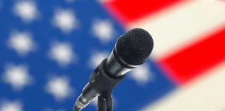 Microphone with blurred American flag background.
