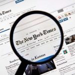 New York Times DECLARES WAR – Sues Pentagon! Magnifying glass over The New York Times website.
