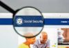 Magnifying glass focusing on Social Security Administration webpage.