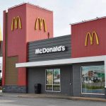 McDonalds restaurant exterior with logo and drive-thru sign.