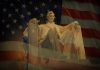 TRUMP DEMOLISHES Historic D.C. Buildings — Emergency Powers ACTIVATED Statue of Abraham Lincoln seated against a backdrop of the American flag