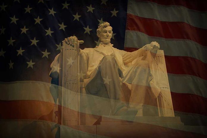 Statue of Abraham Lincoln seated against a backdrop of the American flag