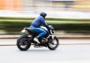 LEGENDARY Bike Empire CRUMBLES – Dealers Shutting Shops A person riding a motorcycle swiftly through an urban area
