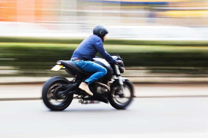 A person riding a motorcycle swiftly through an urban area