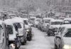 Catastrophic Storm Collides – Pummels 45 Million Americans Traffic jam with cars covered in heavy snow during a snowstorm