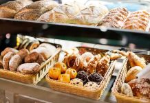 Antisemites FORCE Beloved Jewish Bakery Shutdown A display case filled with various types of baked goods including breads and pastries