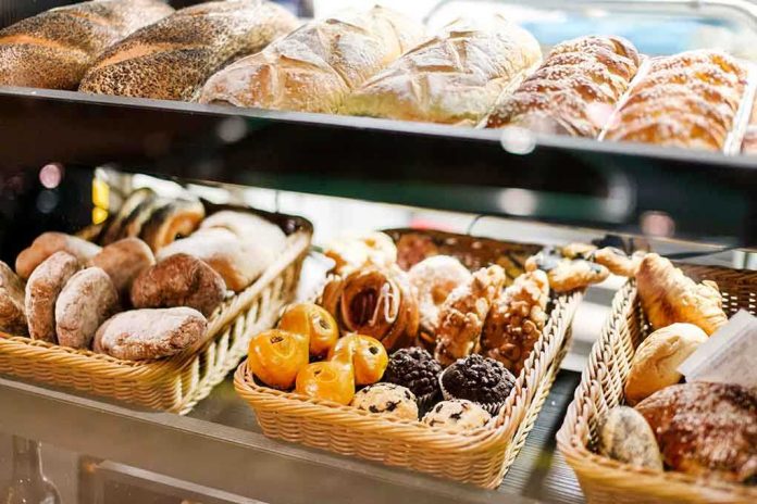 shutterstock_203878693.jpg A display case filled with various types of baked goods including breads and pastries
