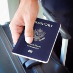 Travel Shock: 39 Nations Targeted, No U.S. Ban A person holding a United States passport next to a suitcase