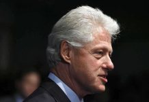 Profile portrait of a man with gray hair in formal attire