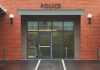 Twerking Cop’s Wild Night Ends Career – She Did What? Entrance of a modern police station with brick facade