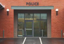 Twerking Cop’s Wild Night Ends Career – She Did What? Entrance of a modern police station with brick facade