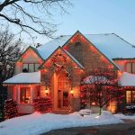 A beautifully decorated house with Christmas lights in a snowy setting