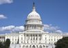 U.S. Capitol building against blue sky.