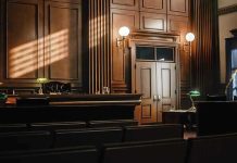 Empty courtroom with judges bench and wooden decor.