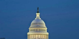 U.S. Capitol building illuminated at dusk.