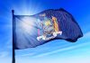 Mamdani’s Top Appointee Blasts Home Ownership as ‘White Supremacy’ New York state flag waving against a blue sky