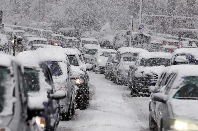 shutterstock_181434689.jpg Traffic jam with cars covered in heavy snow during a snowstorm