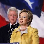 Congress SUBPOENA Clintons – Time to Testify! Hillary Clinton delivering a speech with Bill Clinton in the background