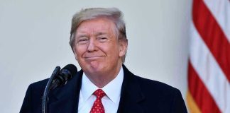 Trump Promises Mass Pardons to Staff Before Terms Up Man in suit and tie speaking at podium.