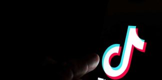 The TikTok Post That Ended a Career Overnight Finger pointing at TikTok logo on a screen.