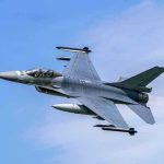 Navy Jet FIRES on Iranian Tanker—Direct Hit! Jet fighter flying through clear blue sky.