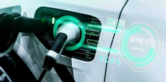 Ferrari Breaks Tradition: Electric FIVE-Seater Stuns! Electric car charging with futuristic display interface.