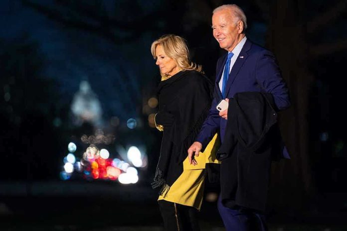 2433568923 Two people walking outdoors at night, lights behind.