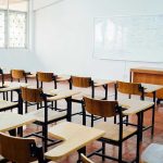 Are Predator Teachers Still in Classrooms? Empty classroom with desks, chairs, and whiteboard.
