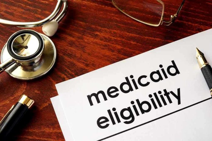 Stethoscope pen document about Medicaid eligibility on table