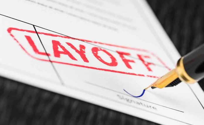 Close-up of a layoff notice with a signature line and a fountain pen