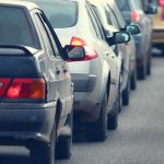 Uncertain Times: Will This Help or Hurt? A line of cars stuck in traffic on a roadway