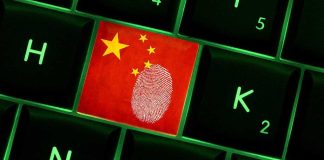 Mayor Busted: Ran Propaganda Machine for China Close-up of a keyboard key featuring the Chinese flag and a fingerprint