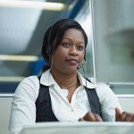 Bank Teller Hangs Up on the Pope – Unbelievable! A woman wearing a headset, focused on her work at a computer in an office setting