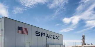 The Trillionaire Narrative Around Elon Musk Relies On More Than Just Today’s Valuation SpaceX building with American flag and launch pad.