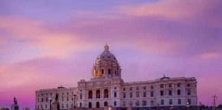 America Turns 250 — And the Fight Over How to Celebrate Is Ugly Historic building with dome under a pinkish-purple sky.