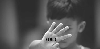 Parents Win Big — California Blinks Child holding up hand with STOP! written on palm.