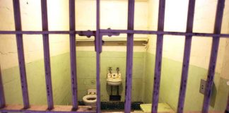 Newark Curfew Declared Around ICE Facility — Who Controls the Streets? Interior of a prison cell with a toilet, sink, and metal bars