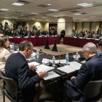 Vaccine Power Grab? Judge Slams The Brakes A formal government meeting with officials seated around a table and media present