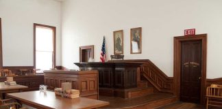 Is ChatGPT an Accessory to Homicide? Interior of a historic courtroom with wooden furniture and an American flag