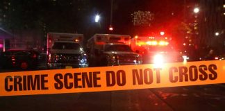 FBI Swarms Hospital—Killer Still Missing Crime scene tape with emergency vehicles in background.