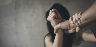 Person restraining another persons hands in conflict