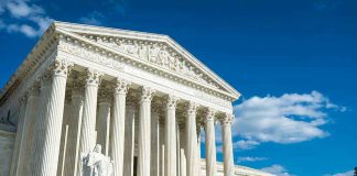 Supreme Court Slams Personal Damages Building with columns under a blue sky.