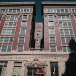 Traveling Conmen Hit Home—One Dead Dallas County Criminal Courts building facade with worker on lift