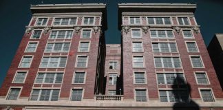 Traveling Conmen Hit Home—One Dead Dallas County Criminal Courts building facade with worker on lift