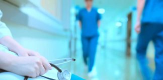 Hospital Roulette: Who’s Treating Patients Tonight? A healthcare professional holding a stethoscope in a hospital corridor