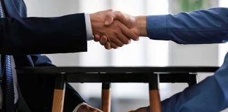 California’s One-Time Hit—Who Runs? Two people shake hands while exchanging cash under a table