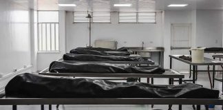 Mud-Filled Lungs Upend Accident Story Mortuary room with covered bodies on metal gurneys