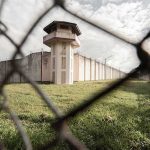 Animal Weapons In Prisons — What’s Next? Prison watchtower behind chain-link fence