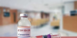 vaccine vial and syringe on a counter in a clinic